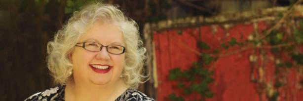 Liz in front of red door BANNER 300